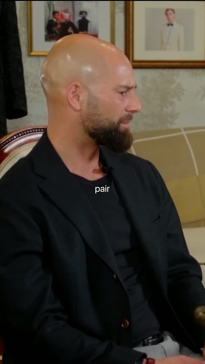 A client seated in the fitting room, talking to Brian Burnett off-camera