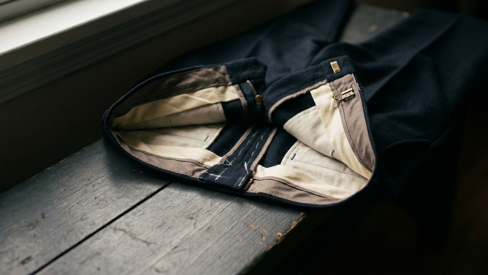 A trouser waistband turned inside out, the centre back seam opened to show the spare cloth within